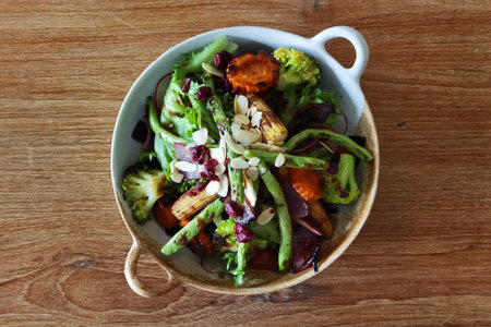 Green lettuce salad with fresh vegetables on the plateの写真素材