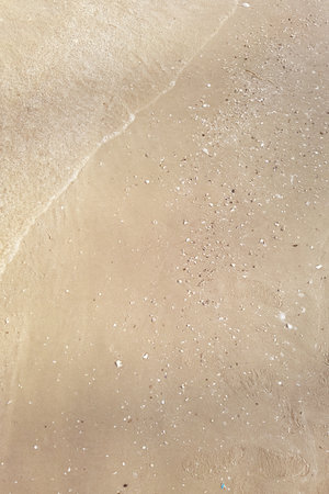 Wave of the sea on the sand beachの写真素材