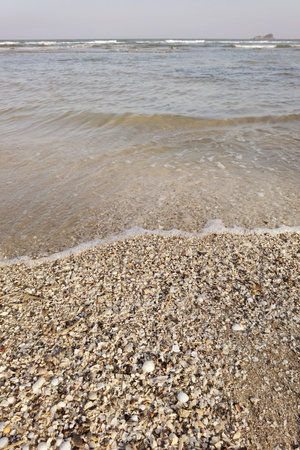 Wave of the sea on the sand beachの写真素材