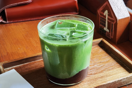 Close up glass of iced matcha green tea on wooden tableの写真素材