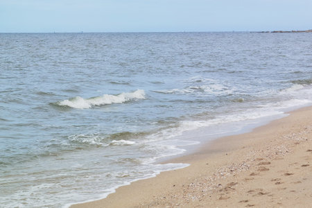 Wave of the sea on the sand beachの写真素材