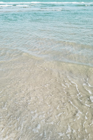 Wave of the sea on the sand beachの写真素材