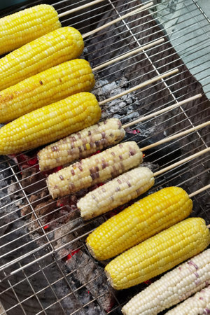 close up of grilled corn on hot stoveの写真素材