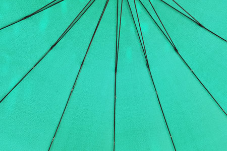 close up of under a green umbrella of its metal framesの写真素材