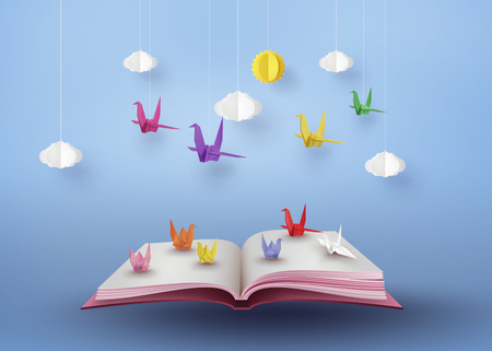 Origami made colorful paper bird flying over open book and  blue sky with cloud . paper art and craft style.のイラスト素材