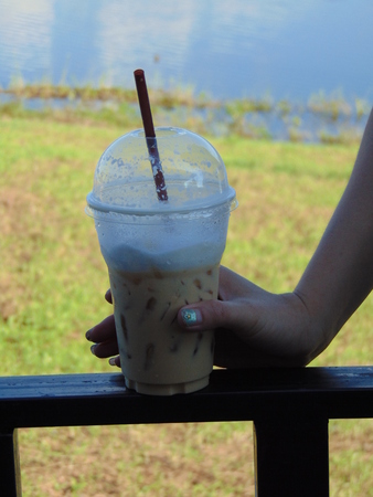 Beautiful hands of women caught cup coffeeの写真素材