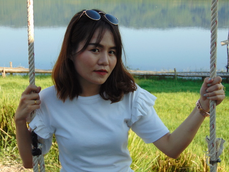 Woman swings in beautiful nature.の写真素材