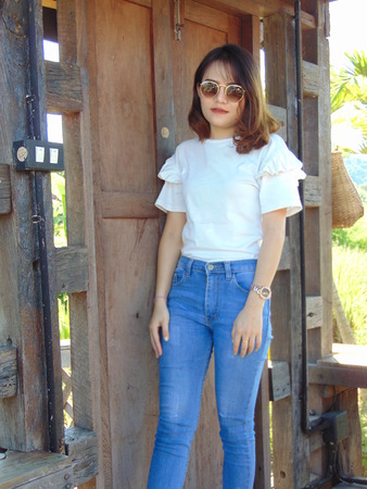 Woman at old wood house looked like she was waiting for some one.の写真素材