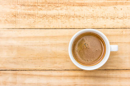 coffee in white cup on wood backgroundの写真素材