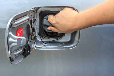 Fuel cap in female handの写真素材