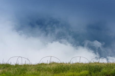 Green grass meadow field with mountain and sky background, Thailandの写真素材