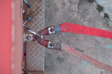 Water hose connected to hydrant during firefighting operation