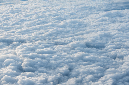 Clouds and sky as seen through window of an aircraft