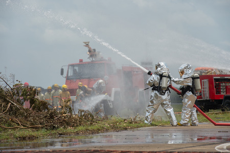 Fire departments & emergency response teams suited up with PPE to protect them from hazardous materials as they investigate this disaster.の写真素材