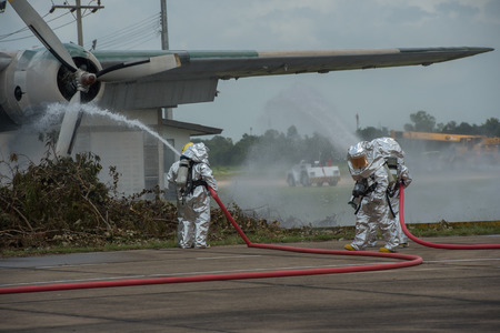 Fire departments & emergency response teams suited up with PPE to protect them from hazardous materials as they investigate this disaster.の写真素材