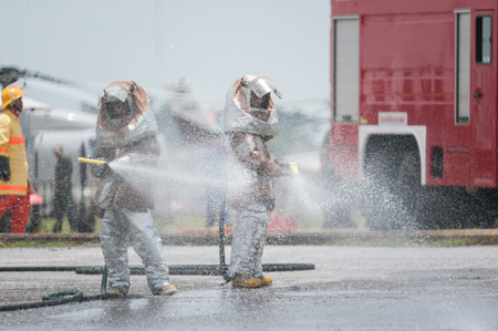 Fire departments & emergency response teams suited up with PPE to protect them from hazardous materials as they investigate this disaster.のeditorial素材