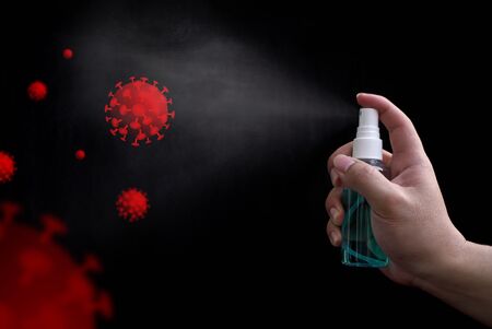 Hand holding 70% alcohol small spray bottle and spraying sterilize Covid-19. concept prevent disease Covid-19.の写真素材