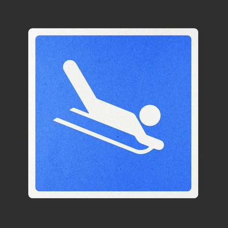 Snow Sledging traffic sign recycled paper on white background.の写真素材