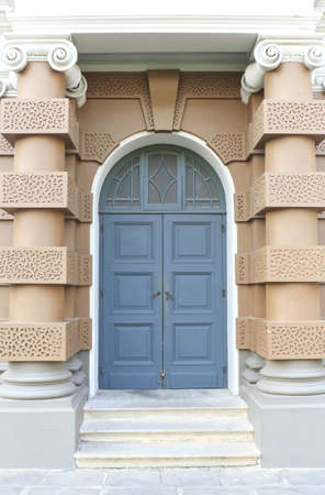 Blue door with brown wall on a new format.の写真素材