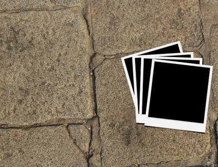 Blank instant photo frames on old brick floor and small cracks  