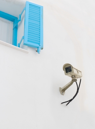 Surveillance Camera mounted on the white wall 