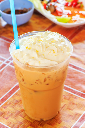 Iced coffee in take away cup on tablecloth.の写真素材