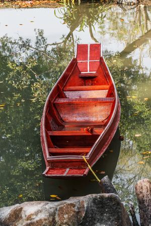 Wooden long boat on a riverの写真素材