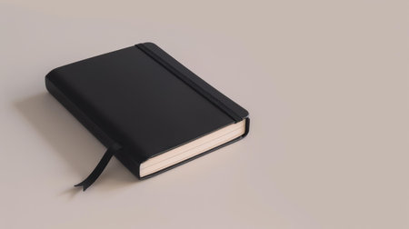 This elegant black notebook features an elastic closure, ideal for keeping your notes organized and secure.の素材