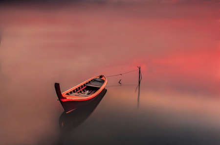 Fishing boat red backgroundの写真素材