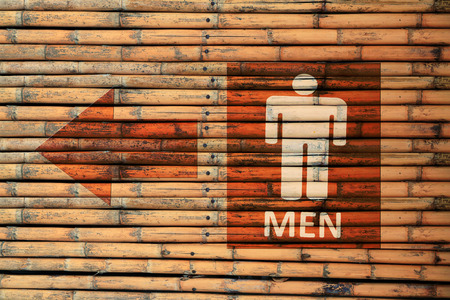 Male Toilet Signs on brown bamboo wood wallの写真素材