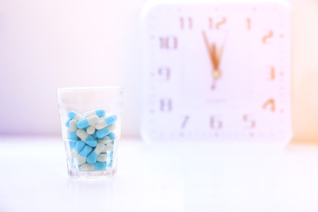 Medicine and clock,  time to take pills.の写真素材