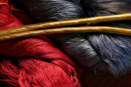 blue and red silk thread with gold raw silk threadの写真素材