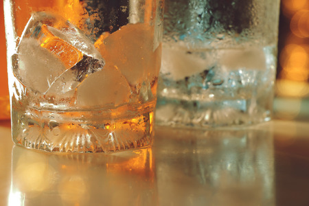 empty glass with ice on counter bar in night clubの写真素材