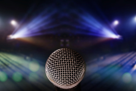 close up microphone with lights on stage background. abstract blurred lights image of concert lighting.の写真素材