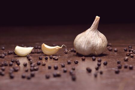 garlic. fresh garlic. cloves of garlic and black pepper, ingredients for thai food on wooden table backgroundの写真素材