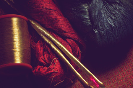 closeup of red , blue, and golden color silk fabric thread for background, vintage style.の写真素材