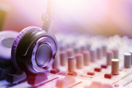 Closeup of headphones on music mixer for dj in nightclub.の写真素材