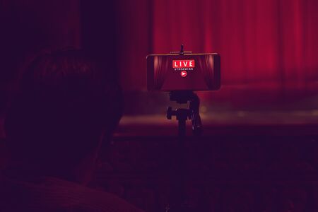 Smartphone on tripod wait for video live streaming in theater, technology social conceptの写真素材