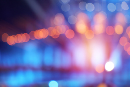 abstract multi-colored light background with defocused bokeh light, the stage of the entertainment...