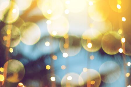 blurred light bokeh with coconut palm tree background on sunset