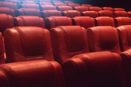 empty theater auditorium or movie cinema with red seatsの写真素材