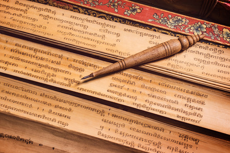 Bangkok, Thailand - November 8, 2018 : pen for writing text on Bai Lan background, Bai Lan or ancient palm leaf manuscripts content about buddhist scriptures, Pali language Khmerの写真素材