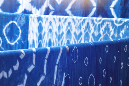 many indigo dyed fabrics, dried at the clothesline backgroundの写真素材