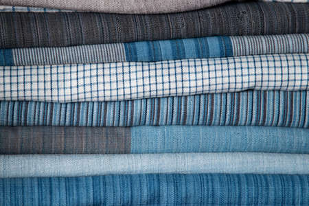 close-up of white and blue pattern cotton fabric texture on shelf in natural fabric shop