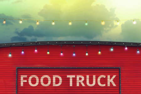 detail of closed red food truck with light bulb in colored sky background, no peopleの写真素材