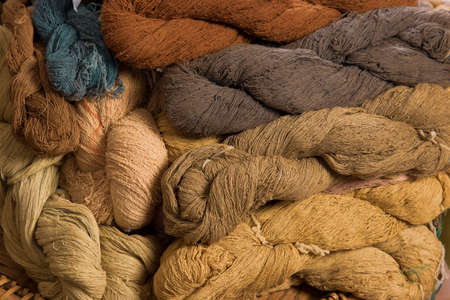 traditional handmade cotton thread from natural dye color with earth tone colour group backgroundの写真素材