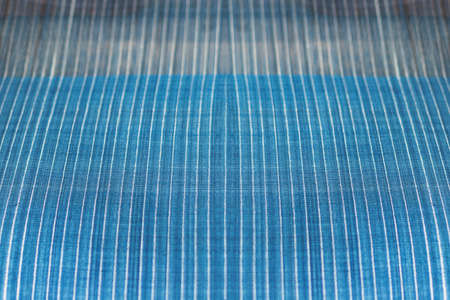 Indigo dyed cotton yarn on loom for handicraft cloth background, detail of texture of traditional Indigo white and blue natural dyed clothesの写真素材