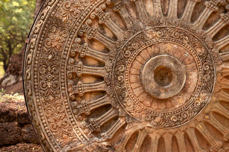 detail of dharmachakra is wheel of dharma or wheel of life, ancient sandstone dharmachakra in the Dvaravati period, symbol of    buddhism entry to Thailandの写真素材
