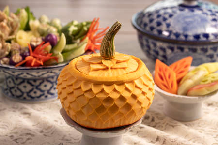 pumpkin carved into flowers on table in restaurant for Thai food and fruits and vegetables carved background.  art of Thai fruit and vegetable carvingの写真素材