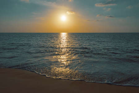 tranquil atmosphere on empty beach and sea at sunset in Thailandの写真素材